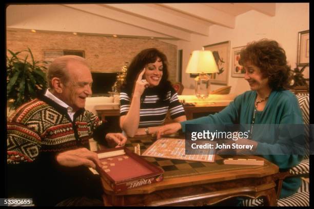 Julie Alban playing Scrabble with her parents Seymour and Reva; she was paralyzed after being shot by boyfriend Brad Ackerman when she informed him...