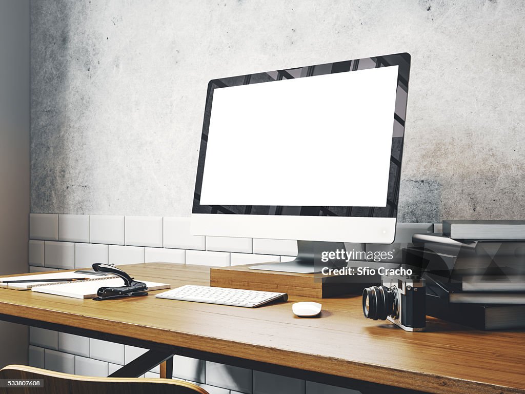 Mock up of generic design computer screen on the table. Workspace in the white loft. 3D rendering