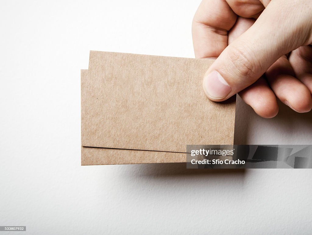 Hand with brown card business cards