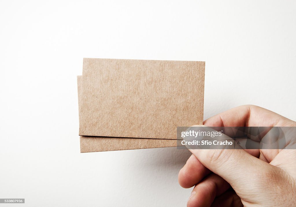 Hand with brown card business cards