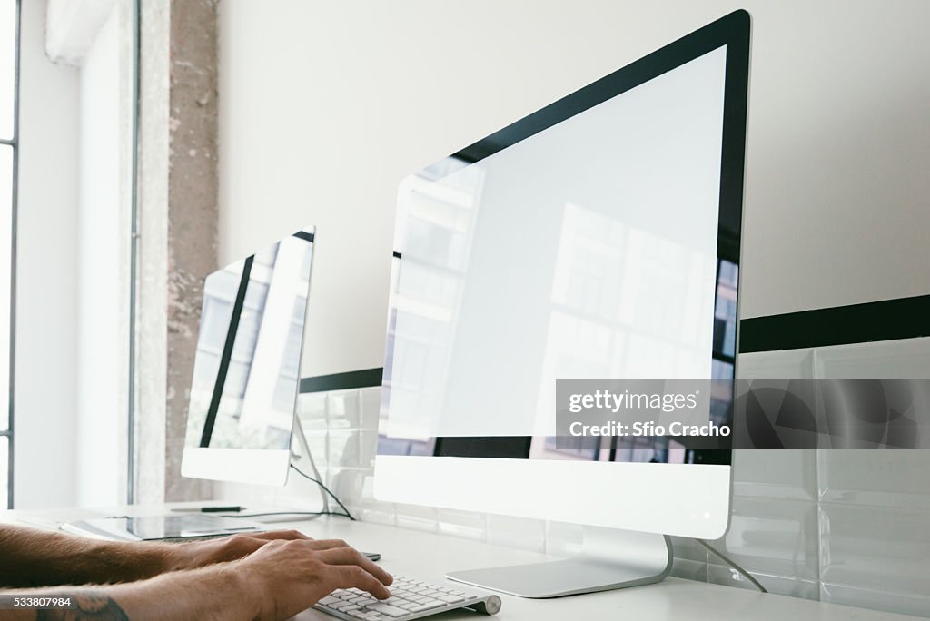 Cropped image of man working on computer