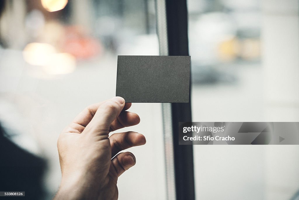 Hand holding business card