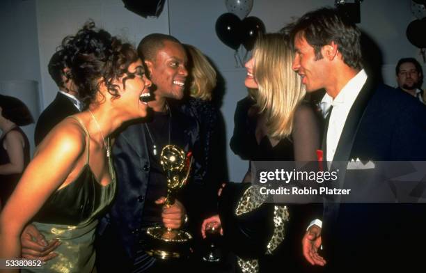 Actor Kevin Mambo holding Daytime Emmy Award won for his work on "Guiding Light," while chatting with costar Sharon Leal and "Sunset Beache's" Hank...