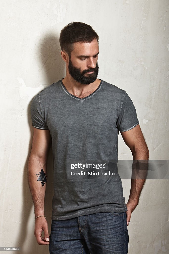Portrait of bearded man wearing grey t-shirt