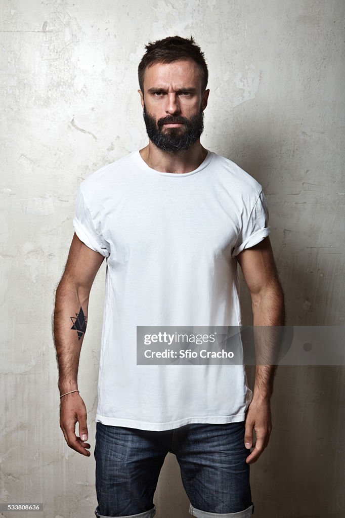 Portrait of bearded man wearing white t-shirt