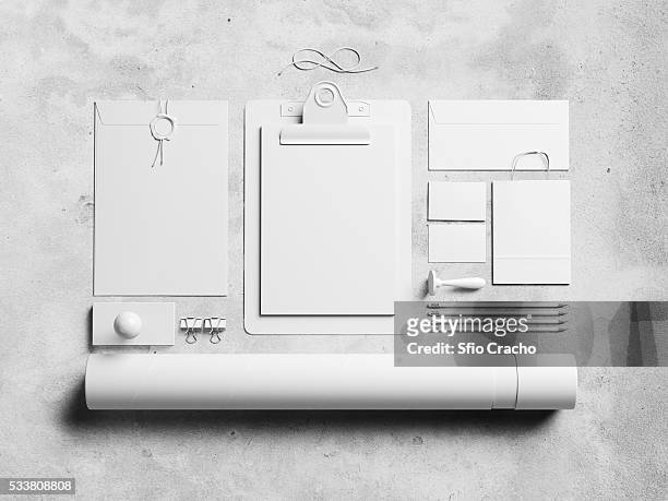 kit of white blank identity elements on concrete background - stamped concrete stockfoto's en -beelden