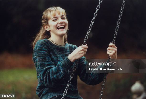 Actress Larisa Oleynik on a swing in her backyard.
