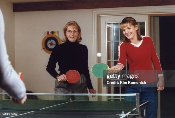 Actress Larisa Oleynik playing ping-pong at home with her mother Lorraine .