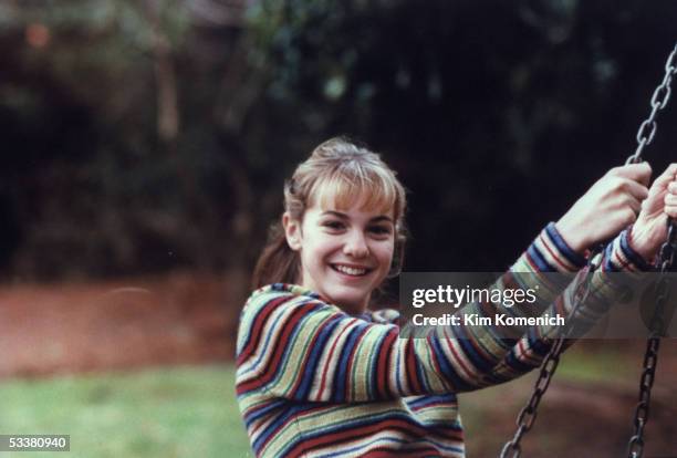 Actress Larisa Oleynik on a swing in her backyard.