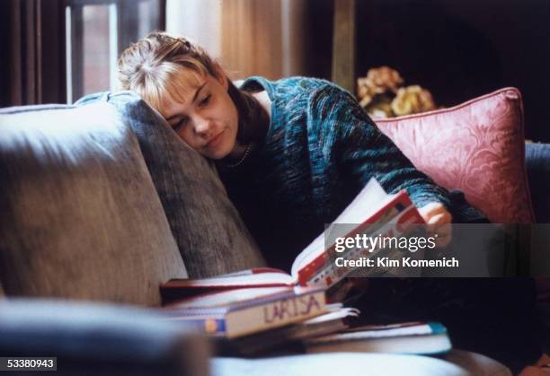 Actress Larisa Oleynik at home reading a book.