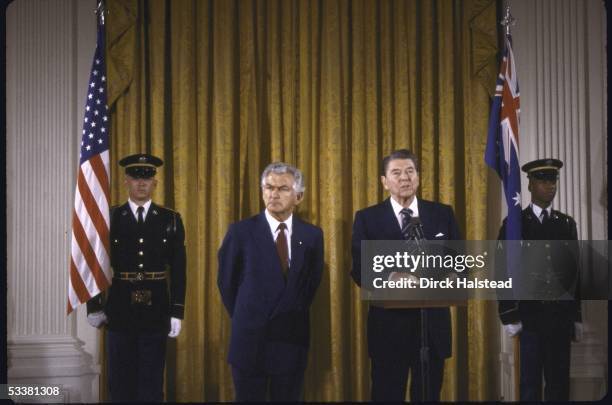 President Ronald Reagan standing in East Room of White House with Australian Prime Minister Bob Hawke .