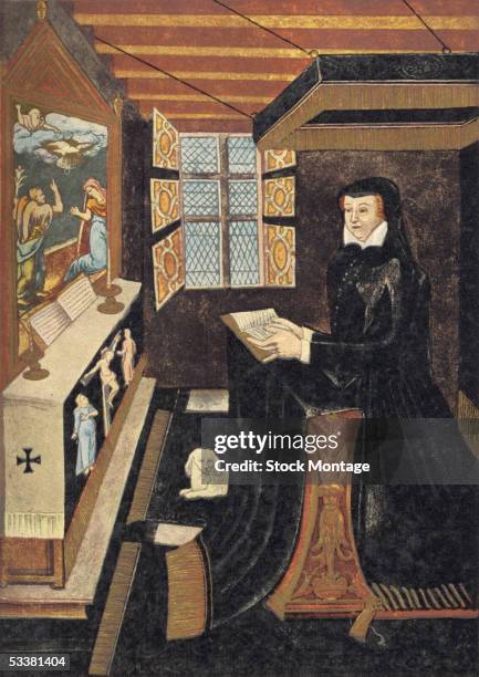 Queen of France Catherine de Medici , wife of King Henry II and daughter of Lorenzo de Medici, in mourning clothes, kneels at her prie-dieu and reads...