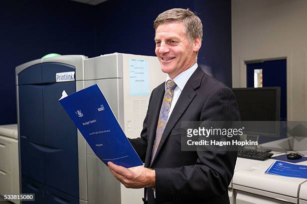 Finance Minister Bill English poses with a copy of his budget speech during the printing of the budget at Printlink on May 24, 2016 in Wellington,...