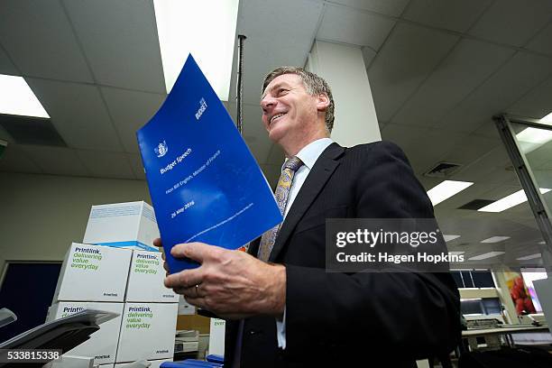 Finance Minister Bill English poses with a copy of his budget speech during the printing of the budget at Printlink on May 24, 2016 in Wellington,...