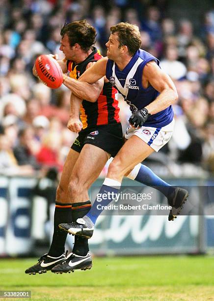 Glenn Archer of the Kangaroos puts a challenge on Aaron Hamill of the Saints during the round 20 AFL match between the Kangaroos and the St.Kilda...