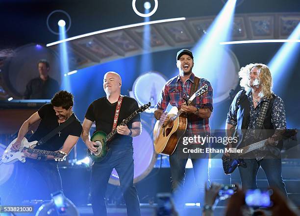 Guitarists Michael Carter and Dave Ristrim, recording artist Luke Bryan and bassist James Cook perform during the 2016 American Country Countdown...