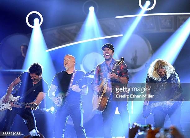 Guitarists Michael Carter and Dave Ristrim, recording artist Luke Bryan and bassist James Cook perform during the 2016 American Country Countdown...