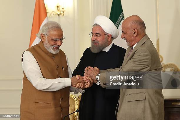 President of Afghanistan Ashraf Ghani , Prime Minister of India Narendra Modi and President of Iran Hassan Rouhani shake hands after they signed...