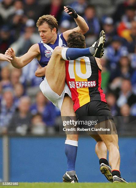 Glenn Archer of the Kangaroos is challenged by Steven Baker of the Saints during the round 20 AFL match between the Kangaroos and the St.Kilda Saints...
