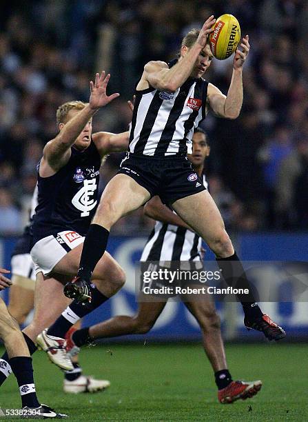 Nathan Buckley of the Magpies marks strongly during the round 20 AFL match between the Collingwood Magpies and the Carlton Blues on August 13, 2005...