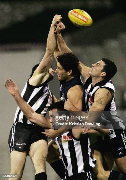 Brendan Fevola for the Blues and Jason Cloke, Shane Wakelin and Simon Prestigiacomo for the Magpies in action during the Heritage Round 20 AFL match...