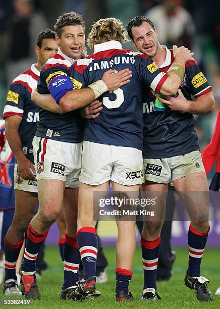 Luke Ricketson, Ryan Cross and Adrian Morley celebrate the Roosters' win during the round 23 NRL match between the Sydney Roosters and the...