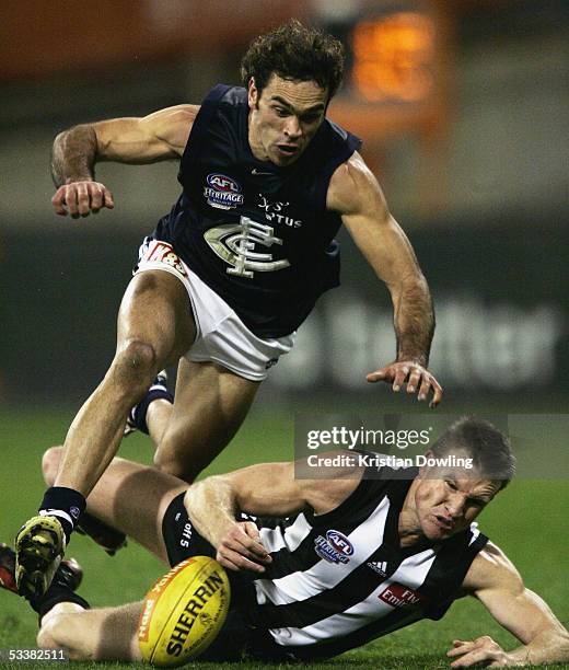 Nathan Buckley for the Magpies and Cory McGrath for the Blues in action during the Heritage Round 20 AFL match between the Collingwood Magpies and...