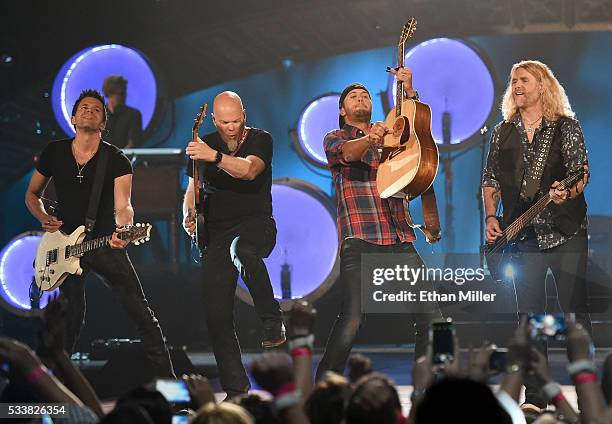 Guitarists Michael Carter and Dave Ristrim, recording artist Luke Bryan and bassist James Cook perform during the 2016 American Country Countdown...