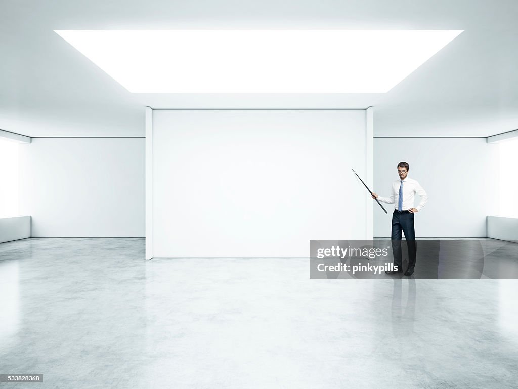 Man with pointer in empty office