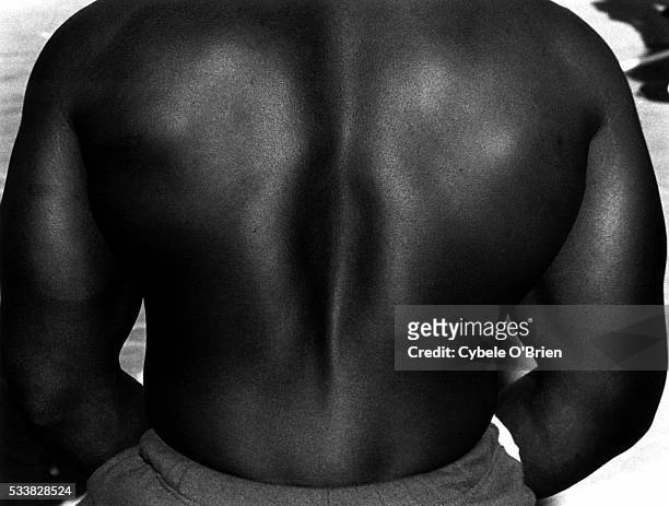 Close up of the bare back of a muscular African American bodybuilder in Venice, California.