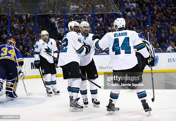 Joel Ward of the San Jose Sharks celebrates with Joonas Donskoi and Marc-Edouard Vlasic after scoring a second period goal against the St. Louis...