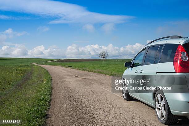 car on a country road - mini van driving stock pictures, royalty-free photos & images