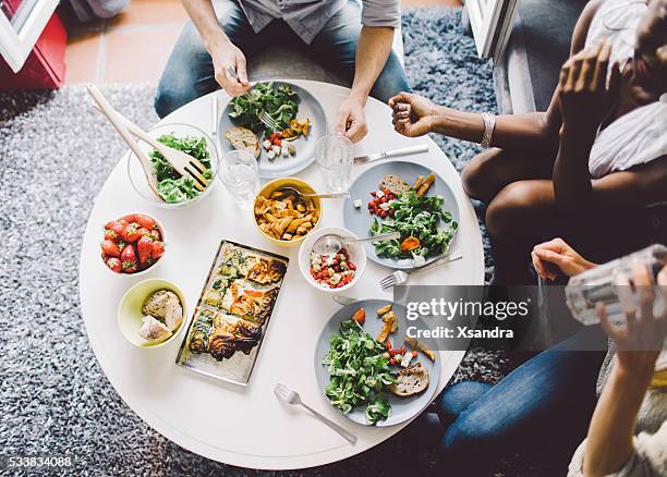 friends enjoying lunch at home - vegetarian food stock pictures, royalty-free photos & images