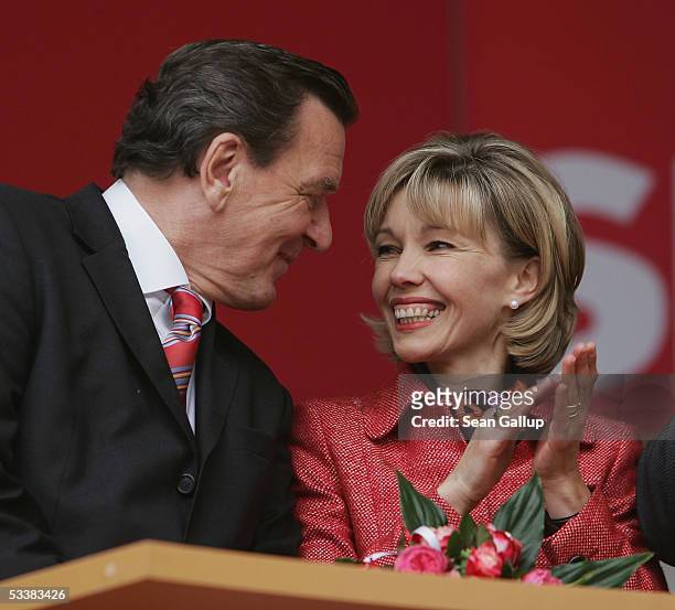 German Chancellor Gerhard Schroeder and his wife Doris Schroeder-Koepf attend his party's official election campaign launching rally August 13, 2005...