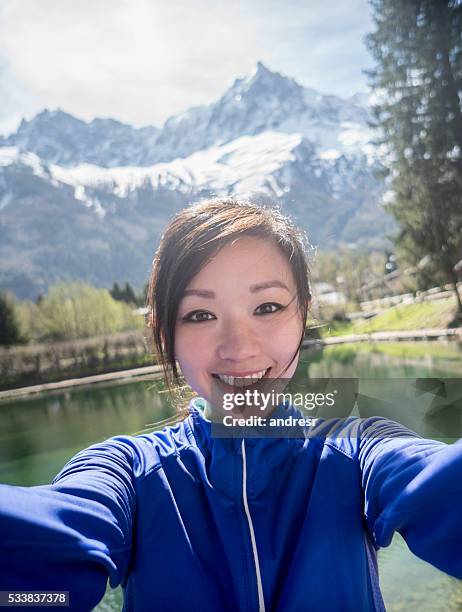 woman taking a selfie while running outdoors - self portrait photography stock pictures, royalty-free photos & images