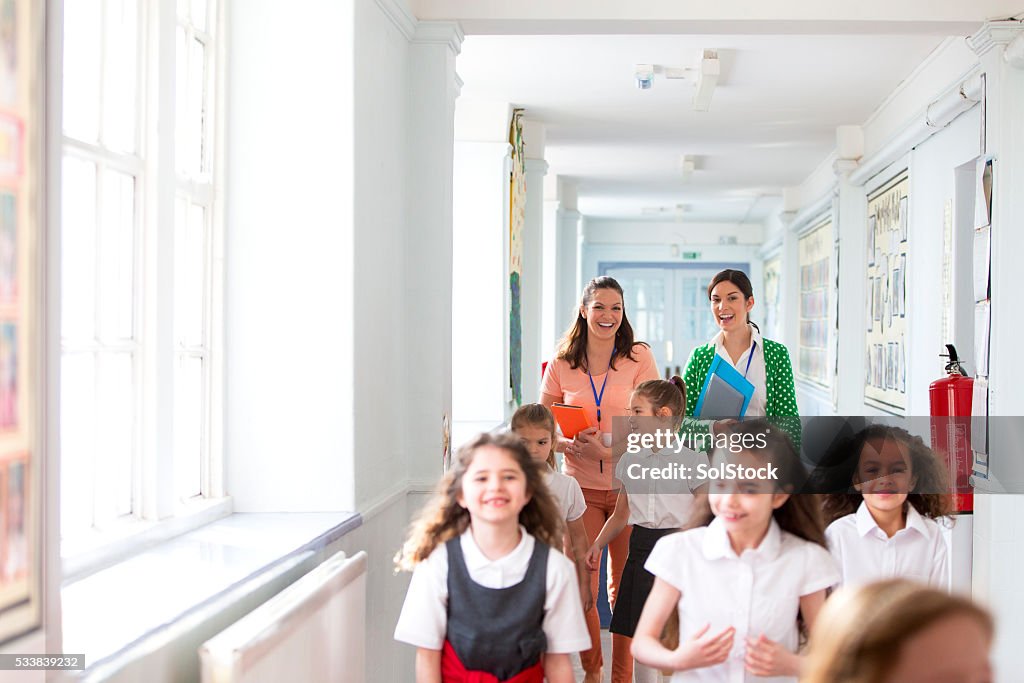 Happy Teachers Walking to Class