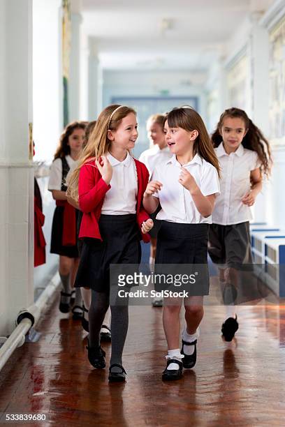 schoolgirls walking to class - school uniform stock pictures, royalty-free photos & images
