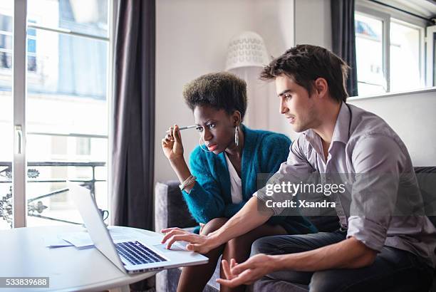 socios de negocios trabajando en su casa - contemplation couple fotografías e imágenes de stock