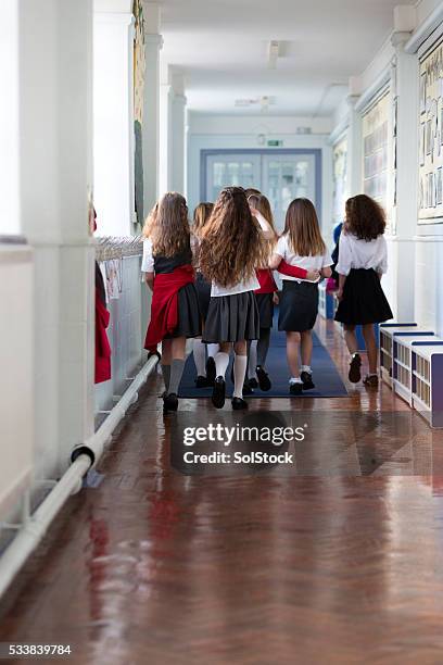 schoolgirls walking to class - skirt stock pictures, royalty-free photos & images