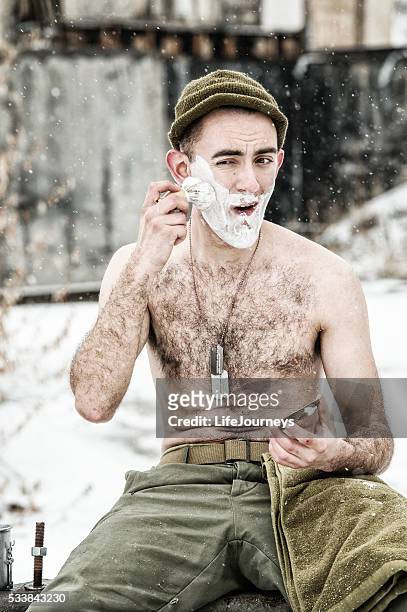 wwii infantry soldier lathering up for a shave - straight razor stock pictures, royalty-free photos & images