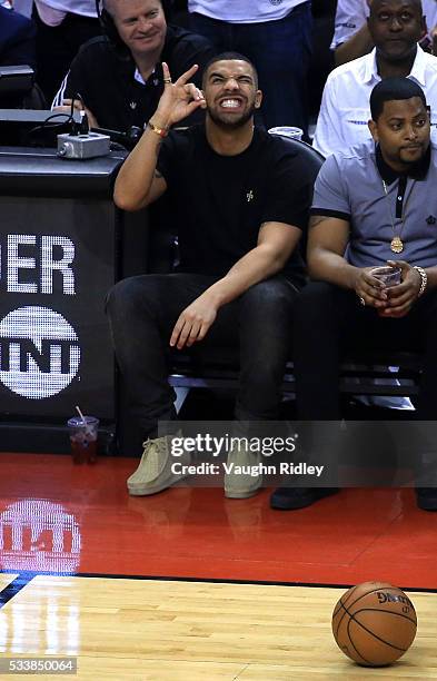 Rapper Drake reacts while sitting courtside in the first half of game four of the Eastern Conference Finals between the Cleveland Cavaliers and the...