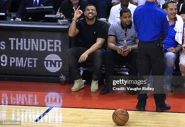 Rapper Drake reacts while sitting courtside in the first half of game four of the Eastern Conference Finals between the Cleveland Cavaliers and the...