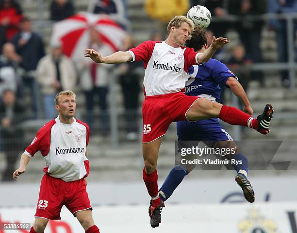 Daniel Bogusz of Siegen looks on while Sascha Backer of Siegen and Christoph Teinert of Unterhaching vie for the header, during the Second Bundesliga...