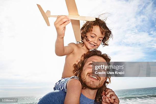 father and son playing - wavy hair beach stock pictures, royalty-free photos & images