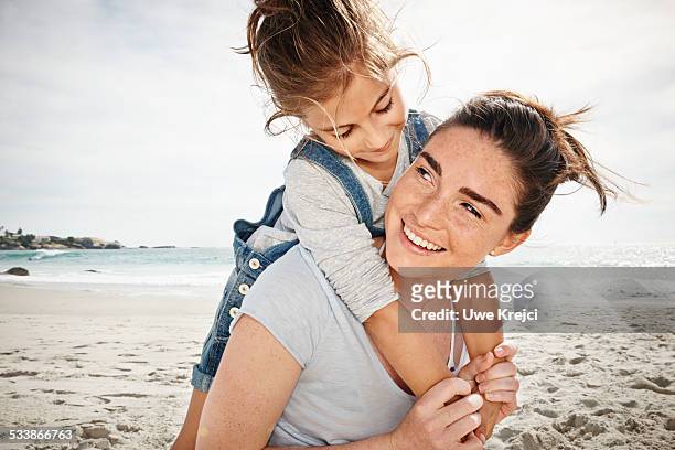 mother and daughter embracing - elemntary stock pictures, royalty-free photos & images