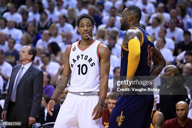 DeMar DeRozan of the Toronto Raptors speaks in the third quarter to LeBron James of the Cleveland Cavaliers in game four of the Eastern Conference...