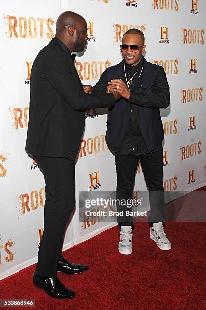 Chris Obi and Tip "T.I. Harris attend the premiere screening of "Night One" of the four night epic event series, "Roots," hosted by HISTORY at Alice...