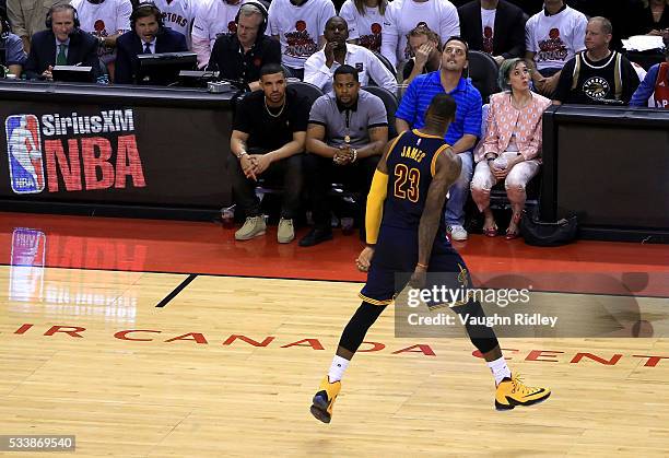 LeBron James of the Cleveland Cavaliers reacts in front of rapper Drake in the fourth quarter against the Toronto Raptors in game four of the Eastern...