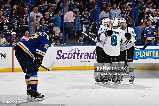 Chris Tierney of the San Jose Sharks celebrates with Joe Pavelski and Marc-Edouard Vlasic after scoring his second goal of the game as Alex...