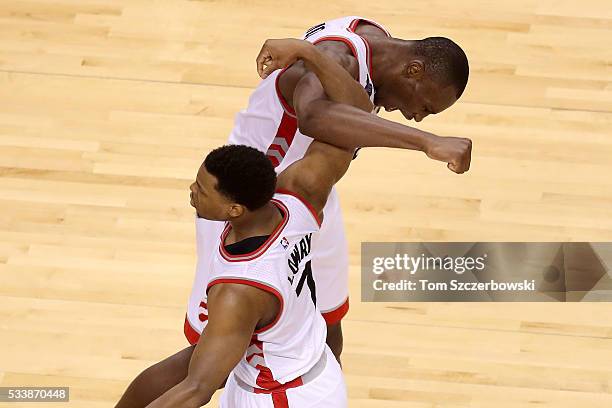 Kyle Lowry and Bismack Biyombo of the Toronto Raptors celebrate late in the game against the Cleveland Cavaliers in game four of the Eastern...